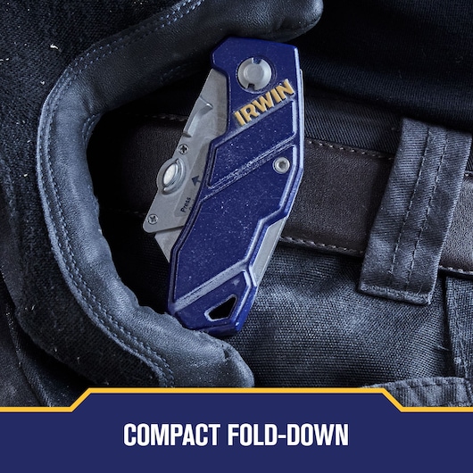 Photo of IRWIN compact fold-down utility knife SKU 2089100 clipped to a belt, blue and silver metal finish.