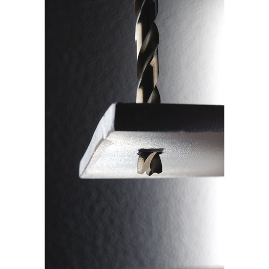 IRWIN 10502225 drill bit cutting through metal. Close-up photography with strong lighting.