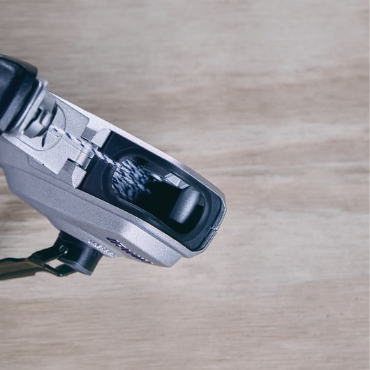 Close-up photo of IRWIN 1932890 chalk line reel dispensing blue chalk, angled on wood surface.