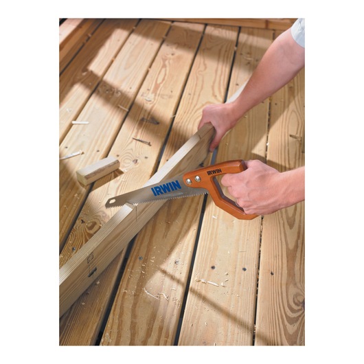 Photo of IRWIN hand saw SKU 2014200 cutting wooden plank on a light wood floor.