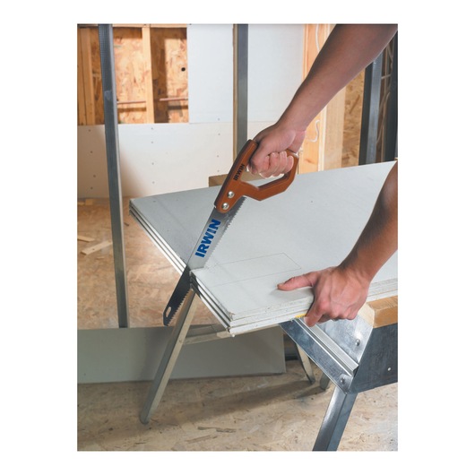 Photo of IRWIN 2014200 hand saw cutting drywall panel in a construction setting.