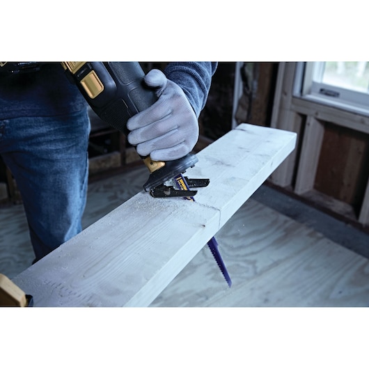 IRWIN 372956 reciprocating saw blade cutting wood, close-up in workshop setting.