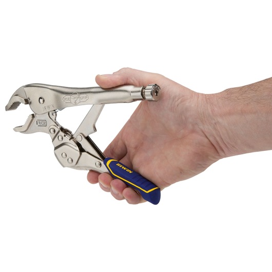 Photo of IRWIN locking pliers IRHT82573 with blue and yellow handle, held in right hand, side view.