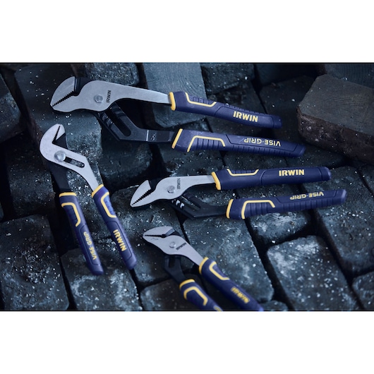 IRWIN 4935322 set of groove joint pliers with blue and yellow handles on dark bricks, angled view.