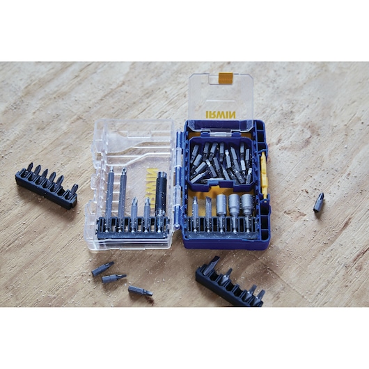 IRWIN IWAF1224 drill and screwdriver bit set in clear plastic case on wood surface, multiple bits visible.