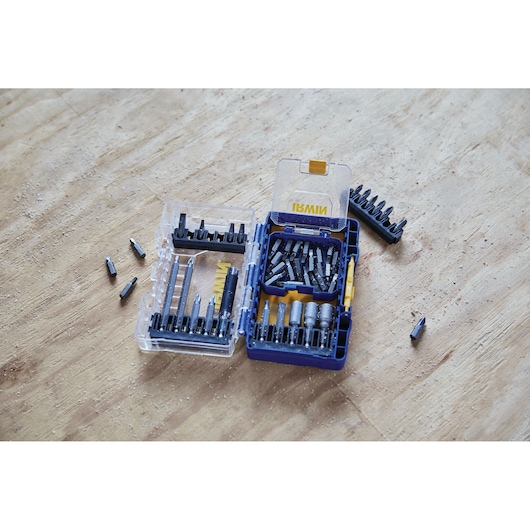 IRWIN IWAF1224 drill and screwdriver bit set in open blue and clear case on wood surface, various bits displayed.