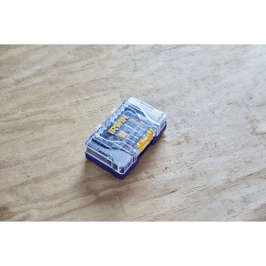 IRWIN IWAF1224 drill bit set in clear plastic case with yellow latch on wooden surface.