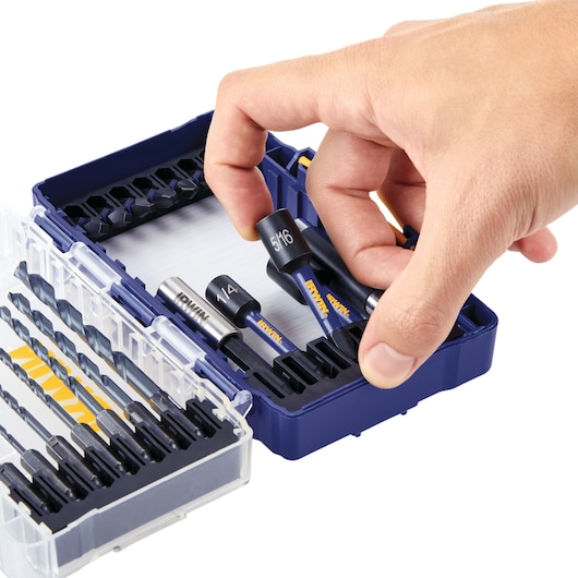 IRWIN drill and drive bit set IWAF1319 with open blue case, various bits organized, hand removing one piece, front angle.