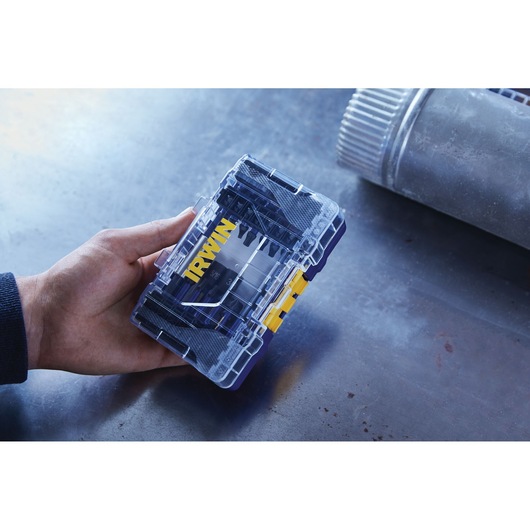 Photo of IRWIN IWAF1326 drill bit set in a transparent plastic case with yellow latch held in hand.