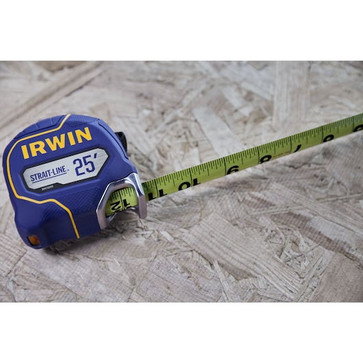 IRWIN (R) TRADE STRONG (TM) Strait-Line (R) Tape Measure Showing Double Sided Feature in Application on Wood Material